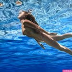 Woman Swimming between the Water Reflections